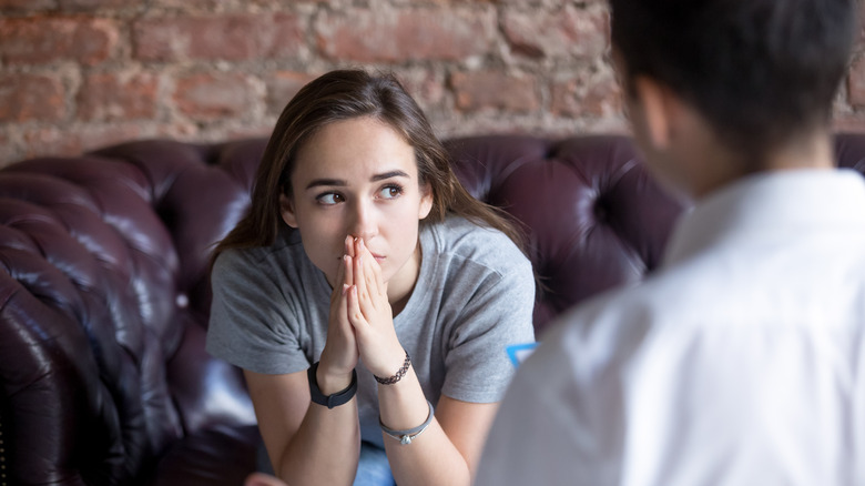 young woman talking with therapist