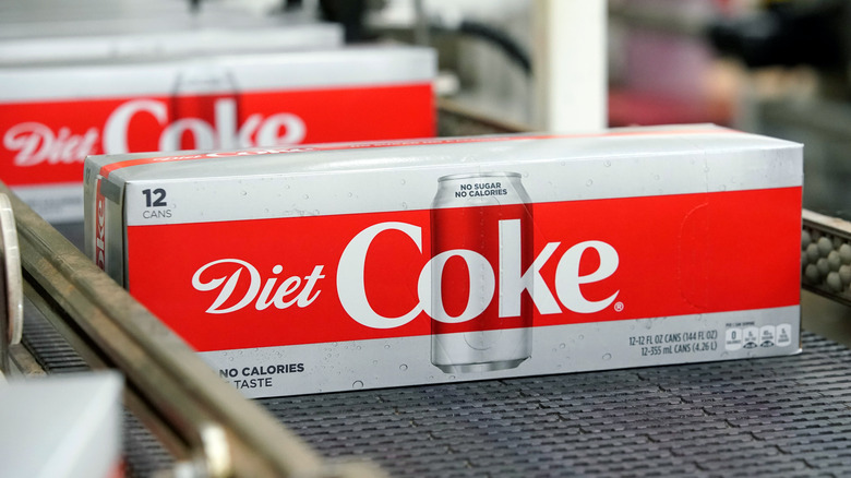 diet coke cases on conveyer belt