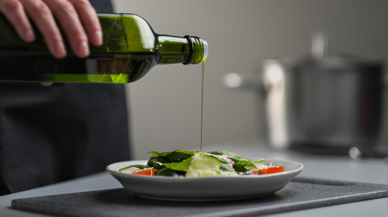 pouring oil on salad