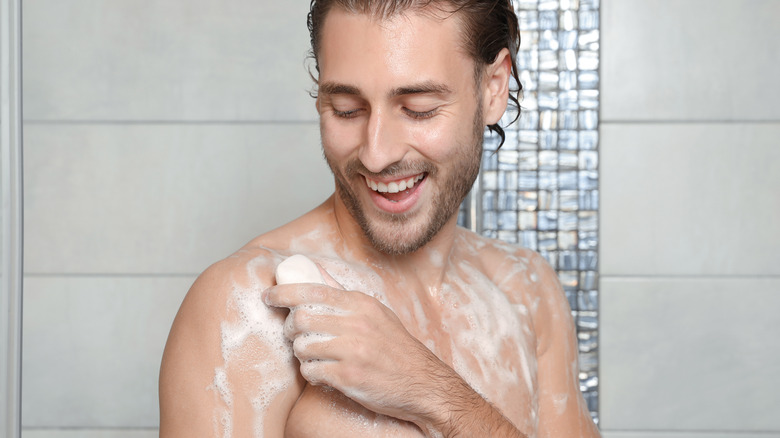 Man showering with bar soap