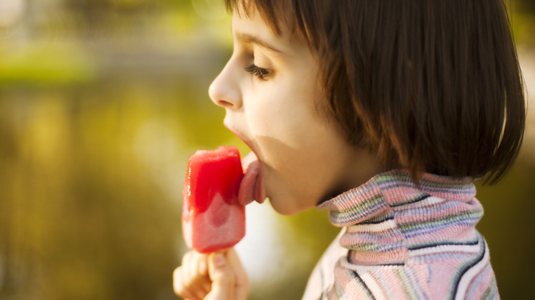 Child licking popsicle