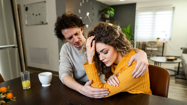 man comforting his depressed wife