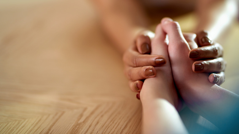 woman holding someones hands