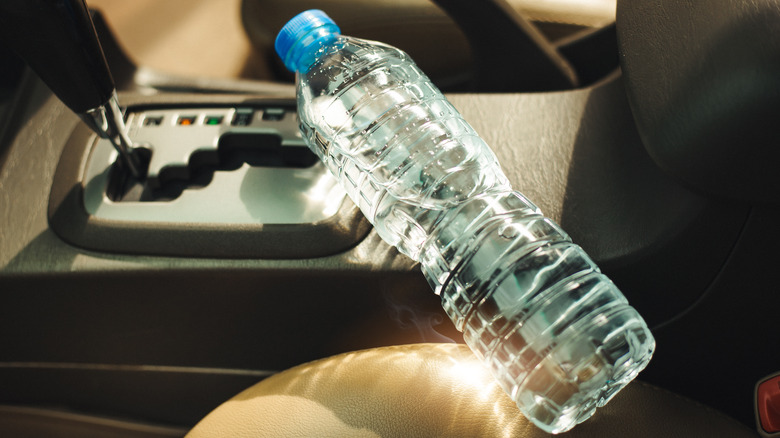 Old plastic water bottle on seat of car