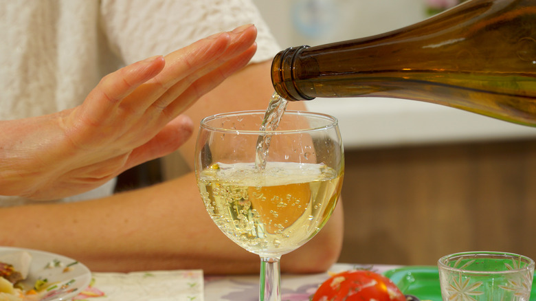 woman's hand stopping pouring wine