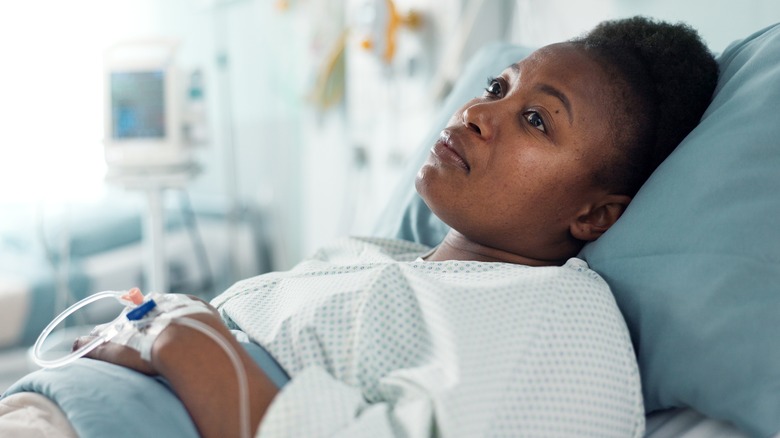 woman lying in hospital bed