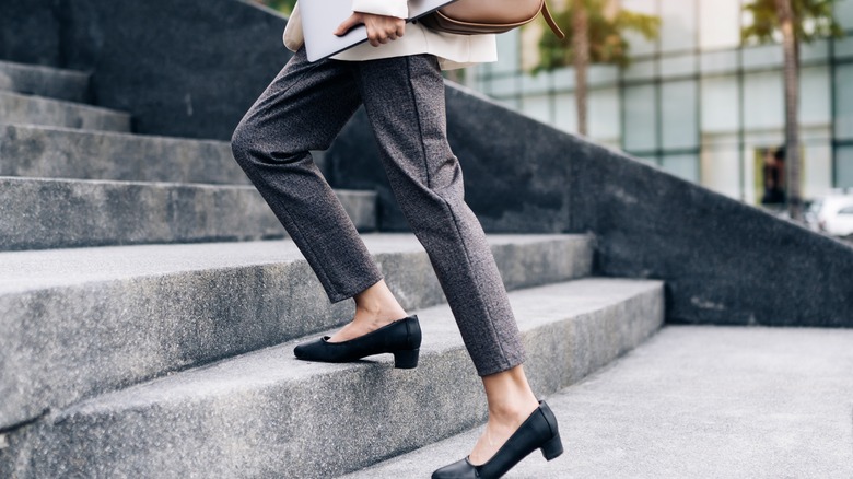 Close up of woman's feet climbing stairs