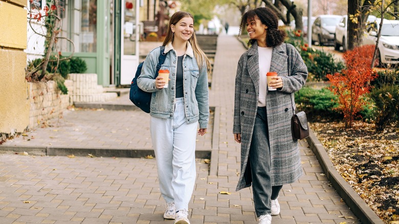 Friends walking down street together