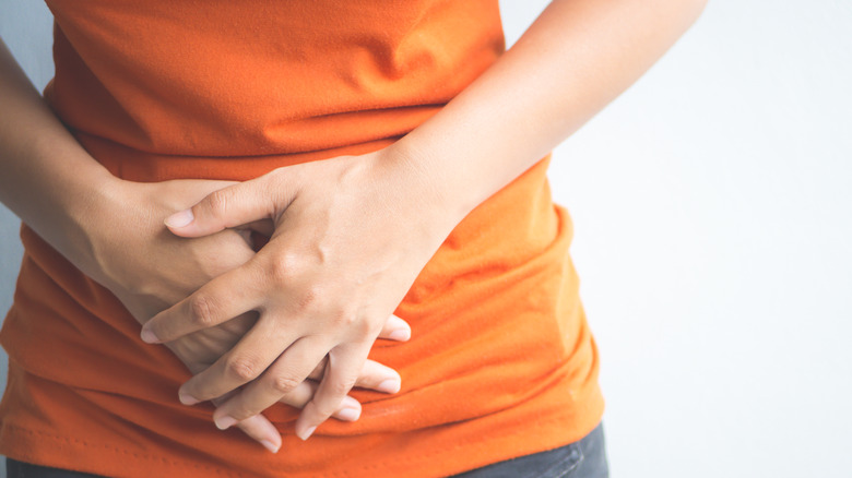 Woman holding stomach