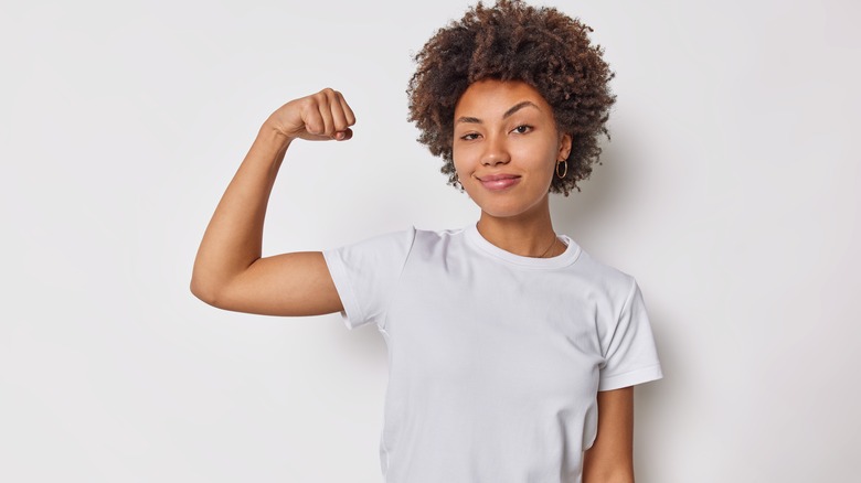 a woman flexing her arm muscle 
