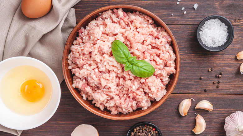 a bowl of ground turkey, salt, and an egg