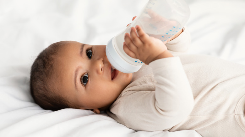 Smiling baby with bottle