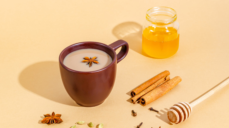 A cup of tea with cinnamon and honey