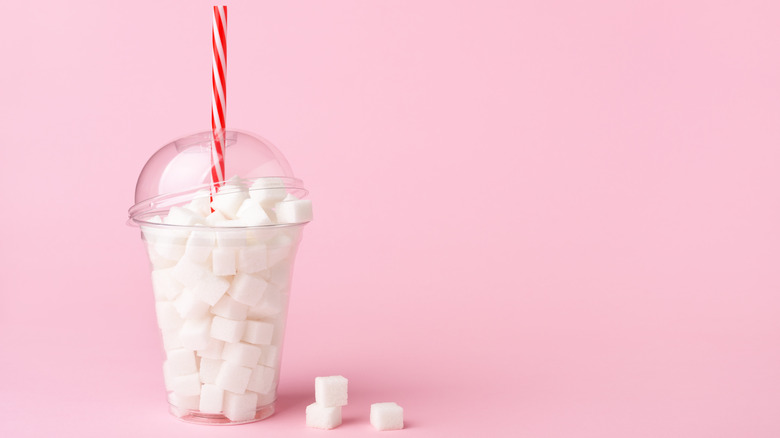 plastic cup full of sugar cubes