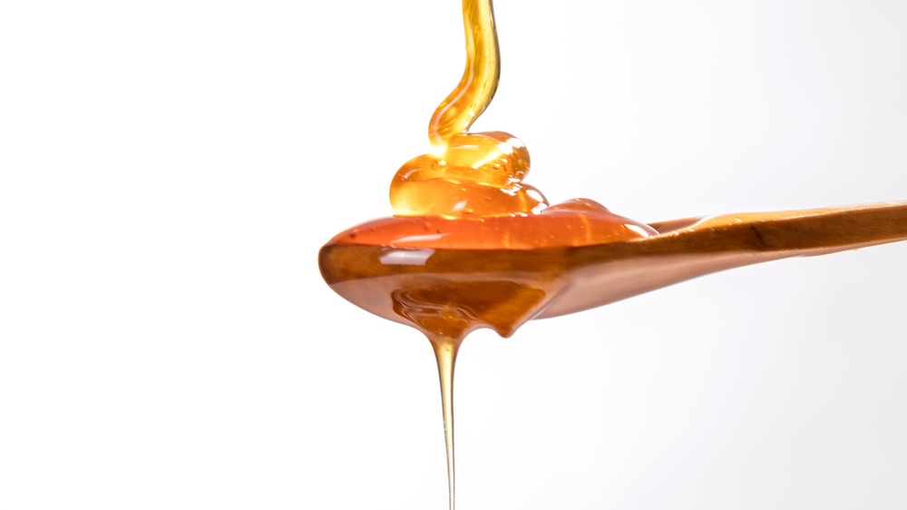 Honey dripping onto spoon