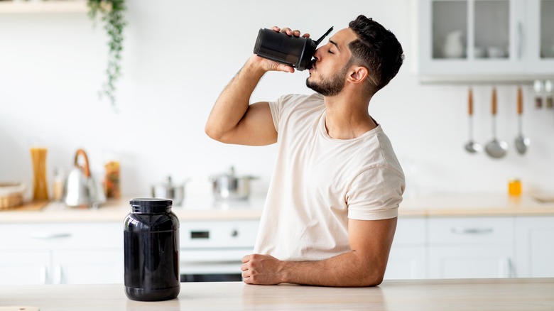 man drinking meal replacement shake