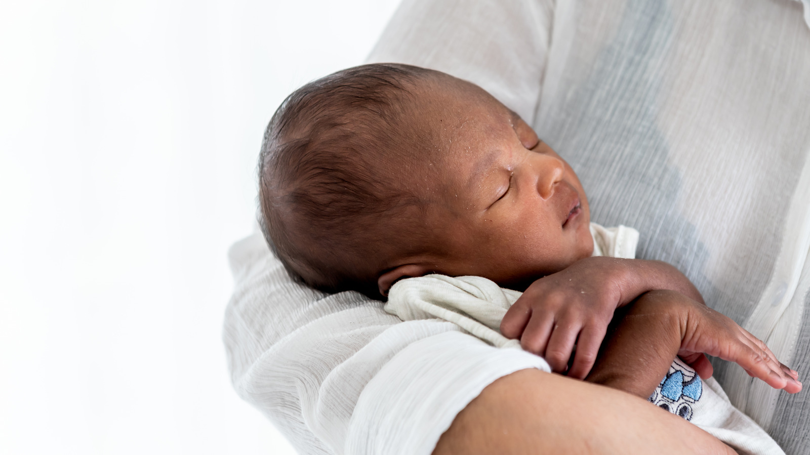 newborn baby rolls on firm mattress conehead