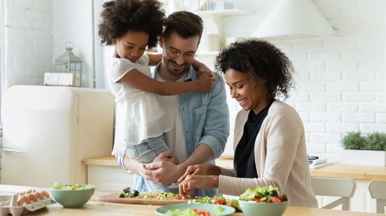 family preparing a breakfast salad