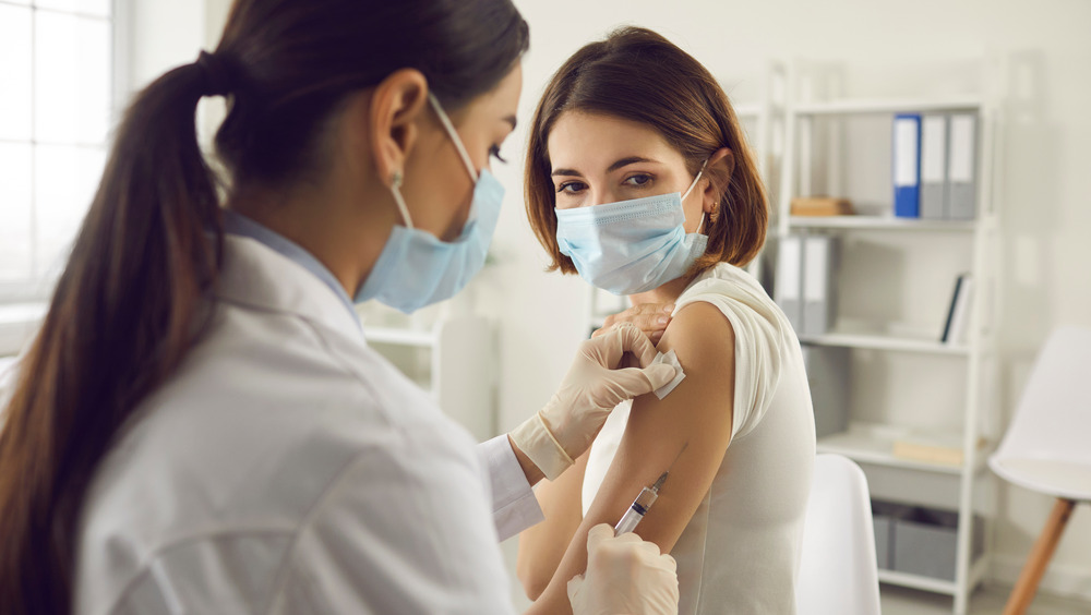 young woman getting vaccine