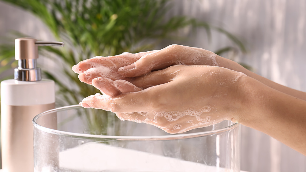 washing hands in sink