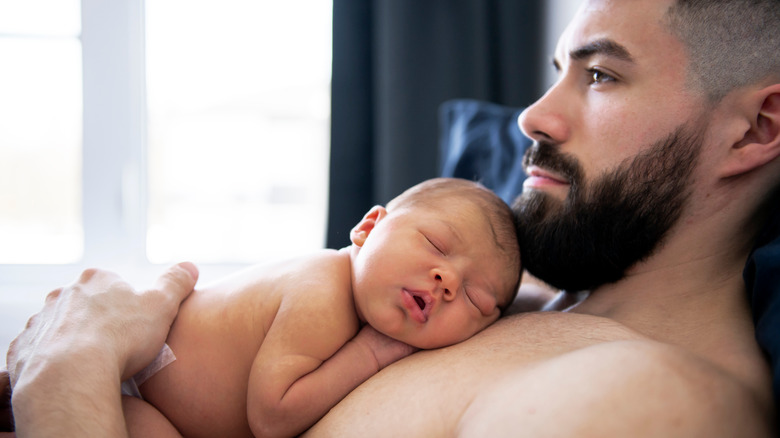 a man holding his newborn baby