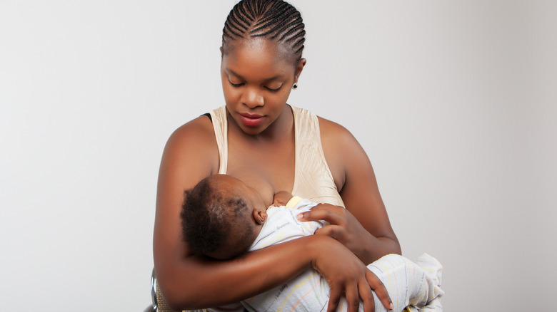 a woman breastfeeds her baby 
