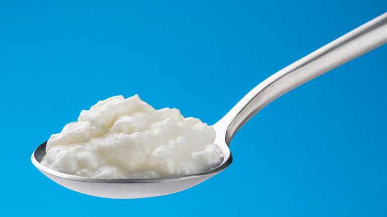 Spoon of curdled milk