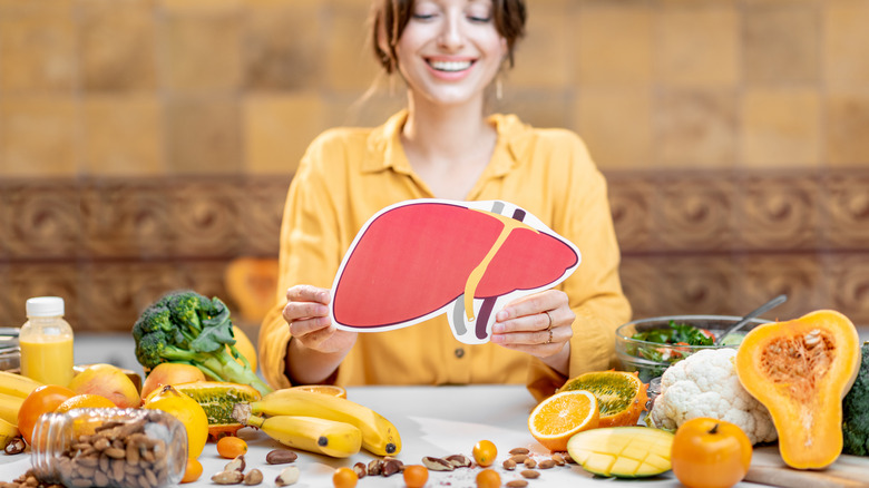 woman holding a liver cutout