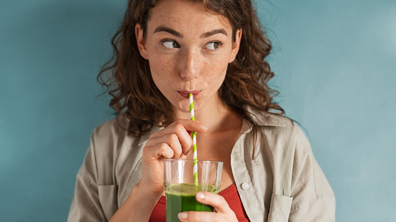 woman drinking vegetable juice
