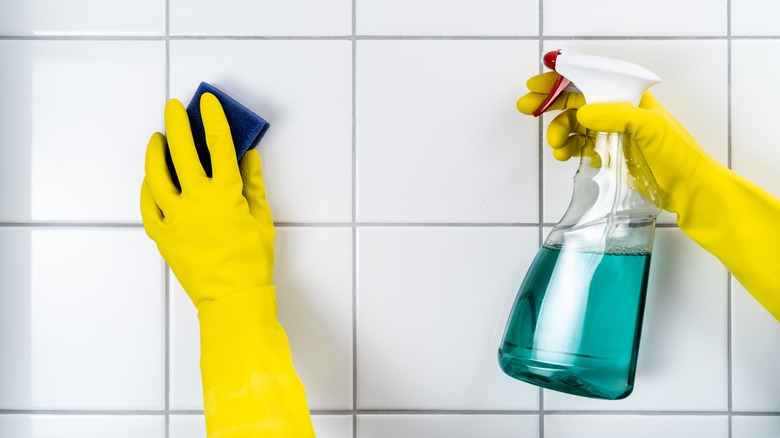 spraying a cleaning solution on a tiled surface