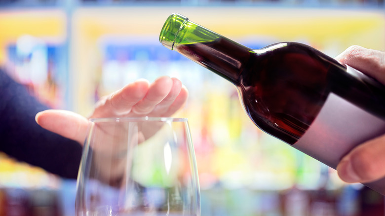 Woman's hand refusing more wine