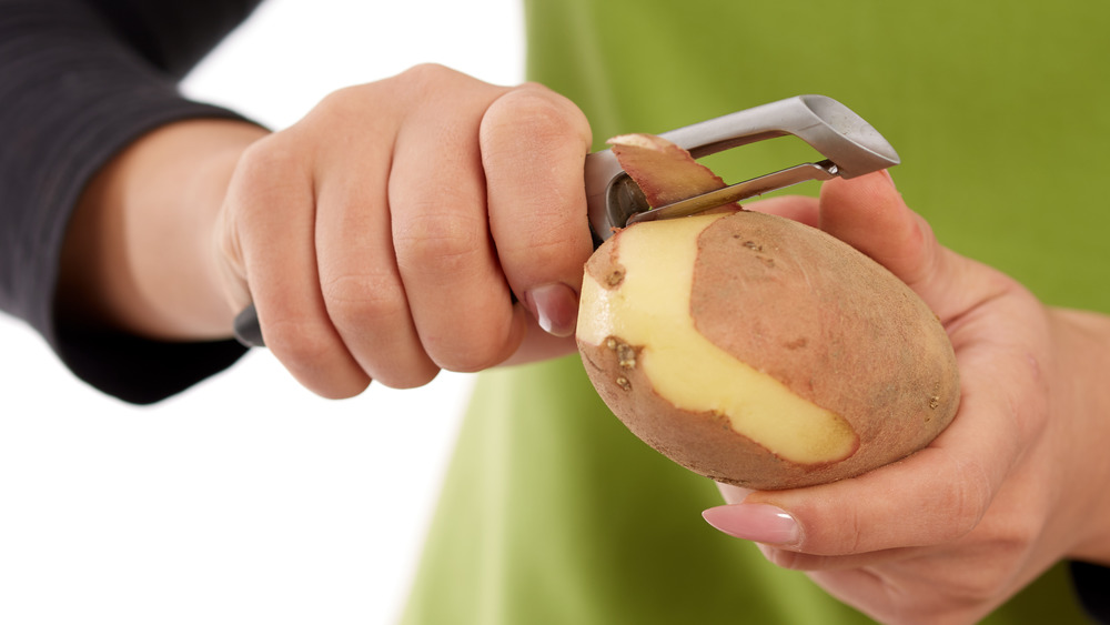 woman peeling potato