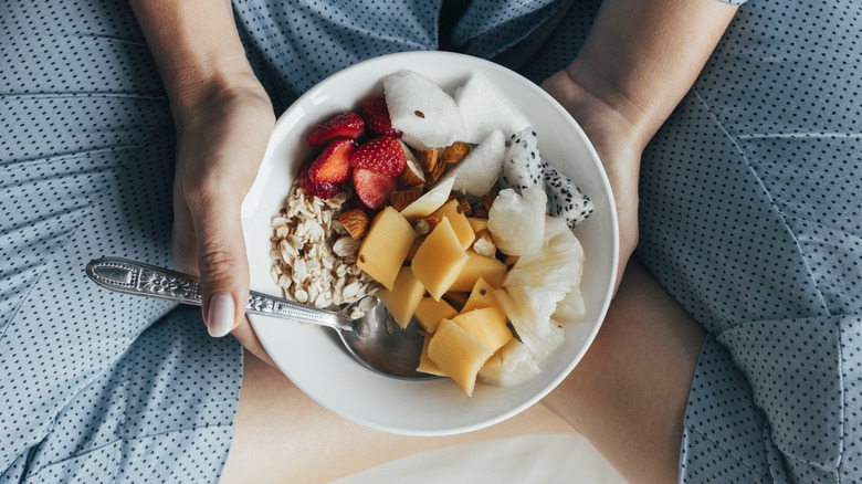 Woman with bowl of fruits