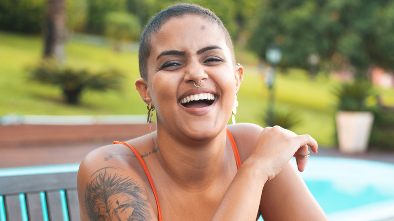 Laughing woman with facial piercings