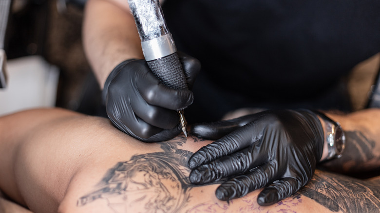 Artist giving man a tattoo