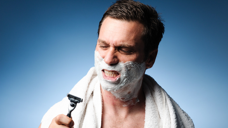 Man shaving face with a razor 