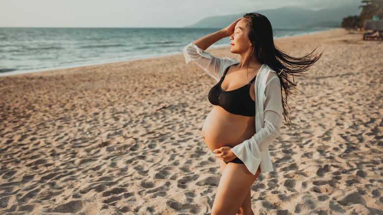 Pregnant asian woman at the beach
