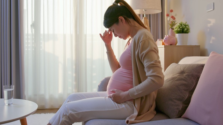 Pregnant woman taking estrogen pills