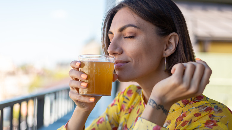 Woman holding beverage to lips