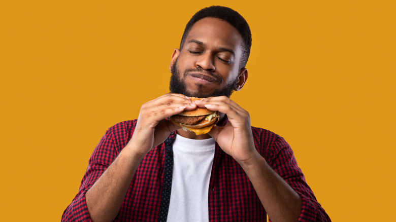 man enjoying burger
