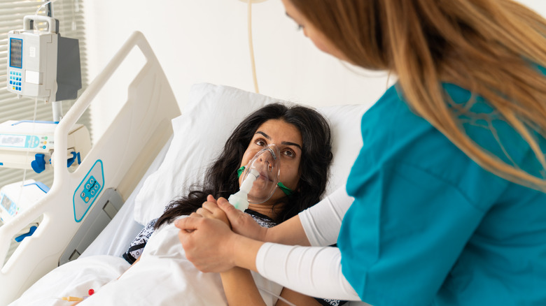 Woman in hospital wearing mask to help breathing