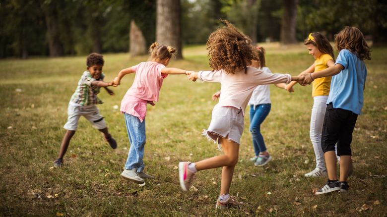 Kids in circle playing outdoors