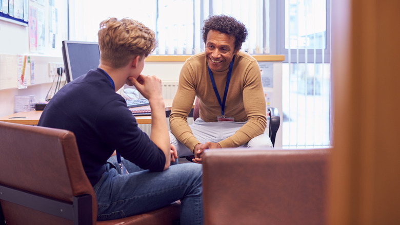 college student speaking with counselor