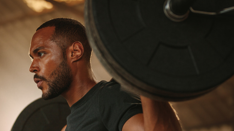 Man with a beard lifting a barbell