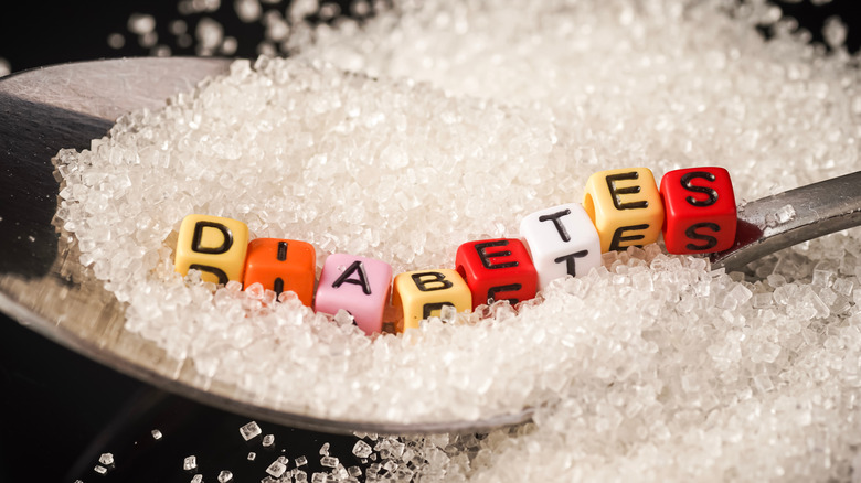 Beads spelling out "diabetes" on a spoon