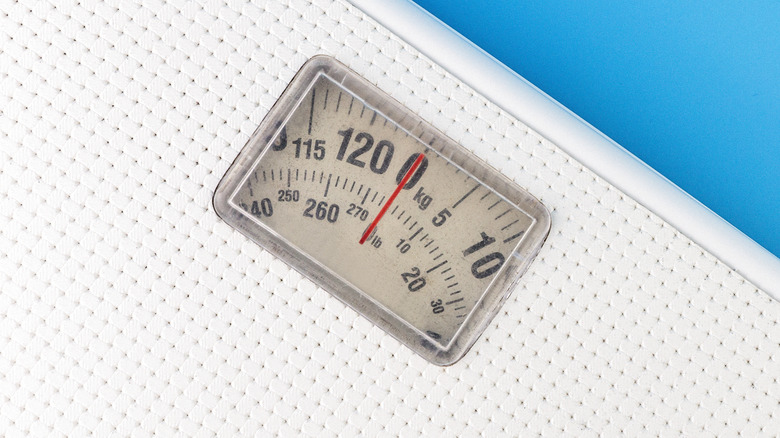 Bathroom scale on a blue background