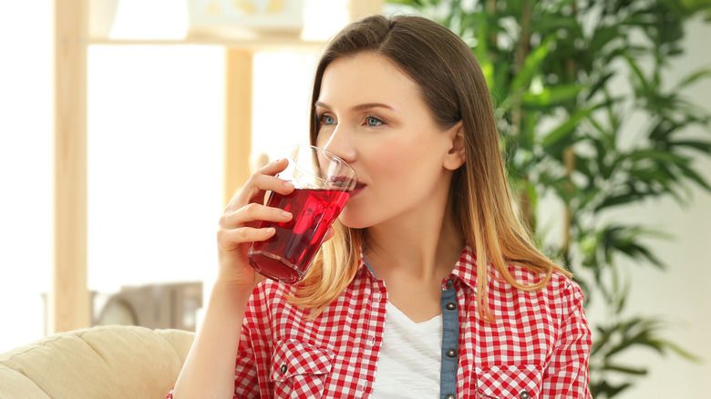 woman drinking cranberry juice