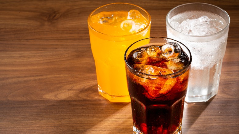 three glasses with different soda options