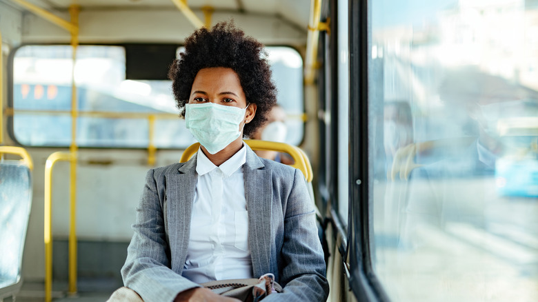 Black woman on train with mask