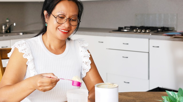 woman making a meal replacement drink